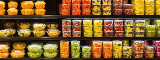 Assortment of cut fruit in plastic containers on display for sale at the supermarket Assortment of cut fruit in plastic containers on display for sale at the supermarket