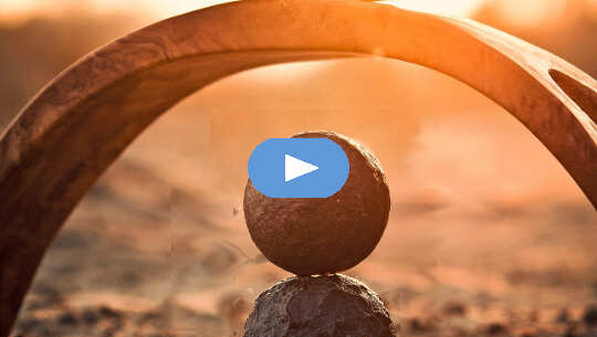 Attaining Balance Between Left and Right-Brain by Nourishing the Solar Plexus Chakra two balls balanced on top of each other under an arch