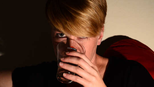 Defeating Addiction by Deflating the Ego and Embracing Self-Esteem and Responsibility woman taking a drink from a glass