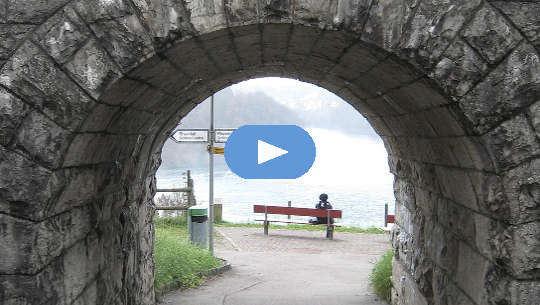 What Will You Do With Your Life Now? person sitting on a bench at the end of a tunnel with signposts pointing left or right