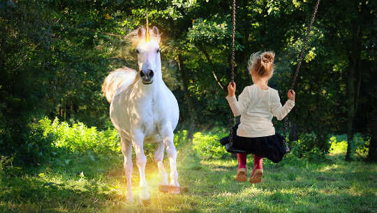 You Can Reawaken Your Potential and Participate in Planetary Rebirth young girl on a swing looking at a unicorn