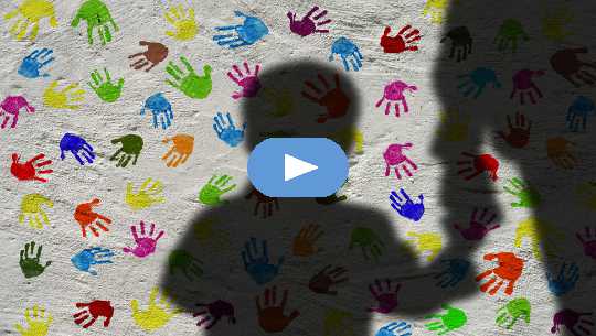 Giving Away Your Power? Going From Fear to Empowerment silhouette of a boy holding an adult's hand, with a background of colorful handprints on the wall