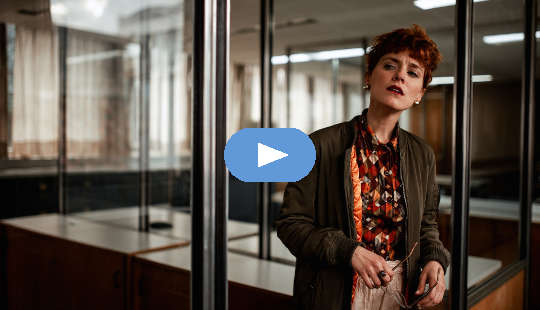 What to Do If You See or Hear Casual Racism or Sexism at Work concerned-looking woman standing in an office setting