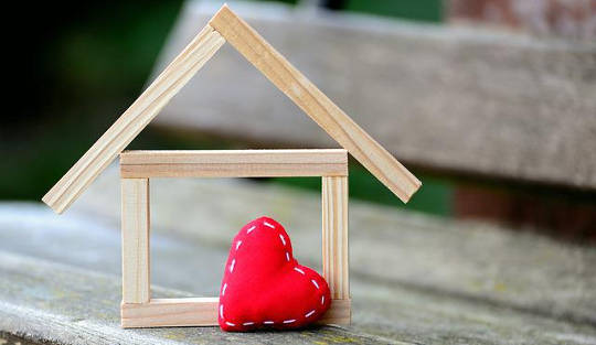 Under Construction: Healing Trauma While Building My Dream a heart with stitching and a home under construction