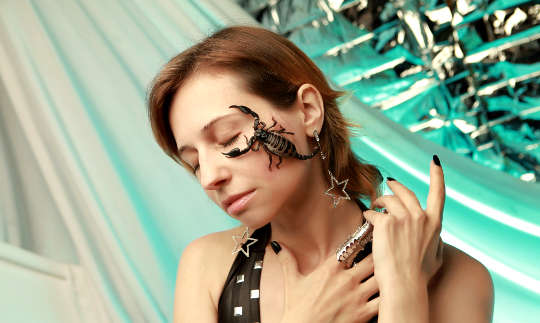 Learning from Your Shadow Animal a scorpion on a woman's face, her eyes are closed