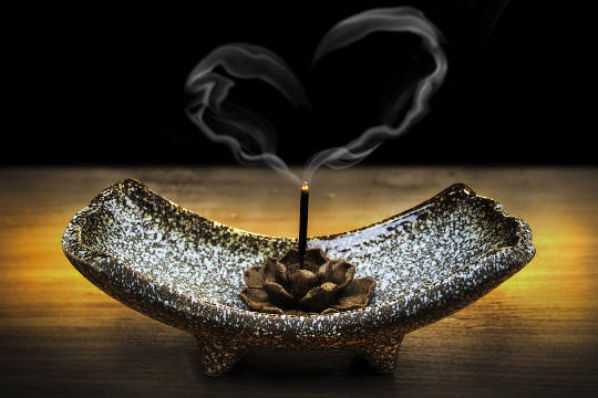 Expressing the Gentle Fragrance of Kindness the smoke from a burning incense stick rises up in the shape of a heart