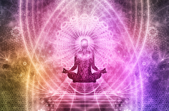 Mindfulness Meditation Is an Evolutionary Sport and We’re All on the Same Team image of a person sitting in meditation surrounded by light