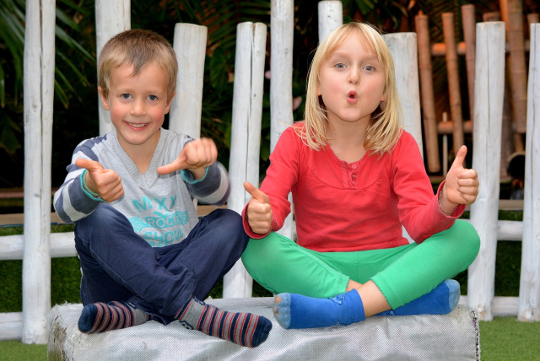 two smiling children outside