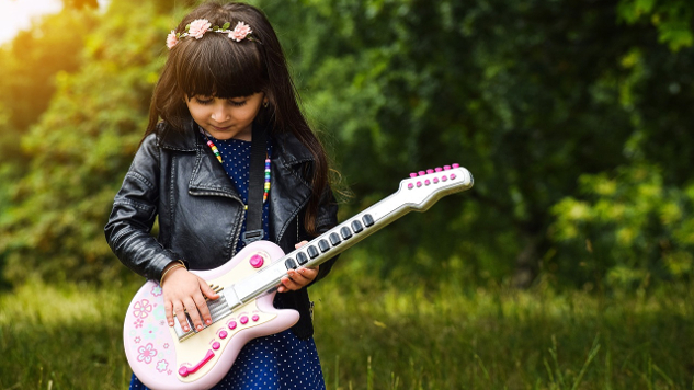 Opening to Passion, Creativity, and the Fire Within young girl with flowers in her hair playing an electric guitar