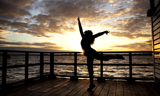 What Could Make Your Life Extraordinary? a woman dancing on a pier