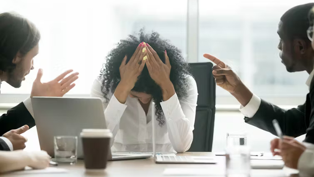 An office setting where employees are using workplace social media platforms