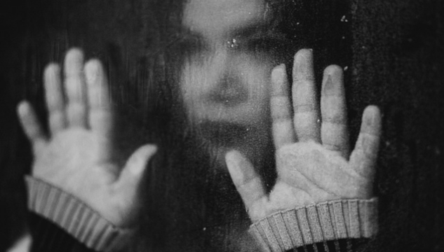 Are You Set in Stone? a blurred image of a woman with her hands flat out on a window. Image by Kleiton Santos from Pixabay.
